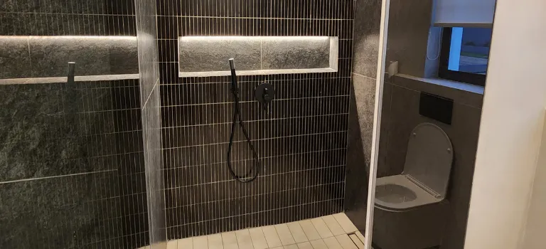 matte black bathroom with  hanging toilet seat